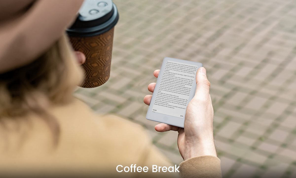 Reading with a compact Xteink eReader outdoors alongside a coffee
